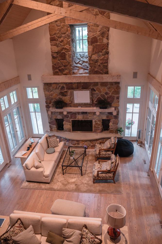 Great room with stone fireplace inside a Providence Farm sober living home in Northbrook, Illinois